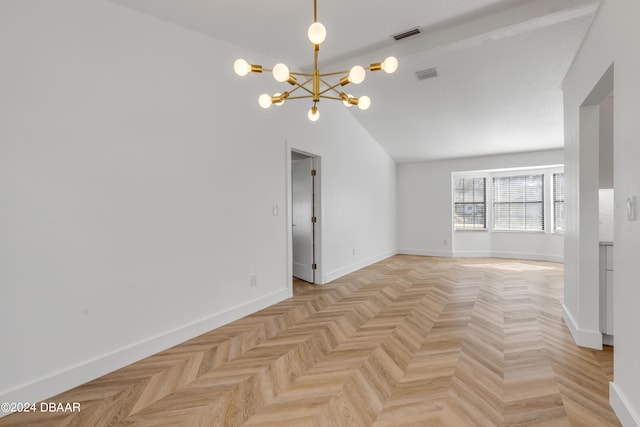 spare room with a chandelier, light parquet flooring, and vaulted ceiling