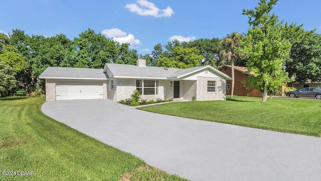 ranch-style home featuring a garage and a front lawn