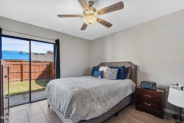 bedroom with ceiling fan, a textured ceiling, and access to outside