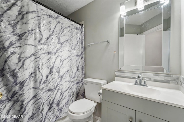 bathroom with vanity, a textured ceiling, toilet, and walk in shower