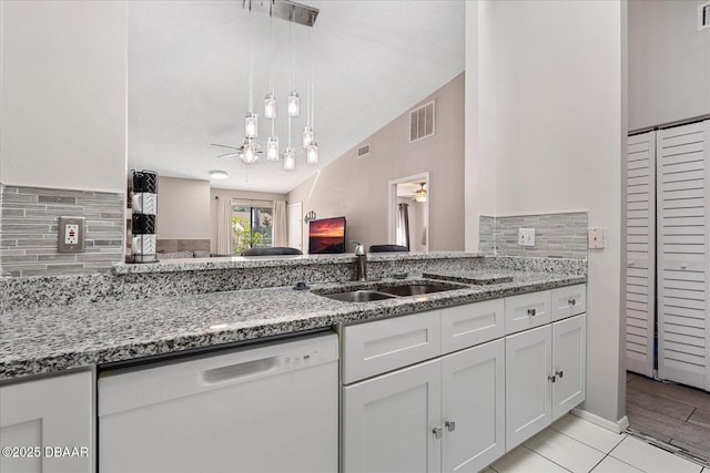 kitchen featuring sink, white cabinetry, dishwasher, ceiling fan, and light stone countertops