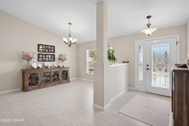 foyer featuring lofted ceiling and a notable chandelier