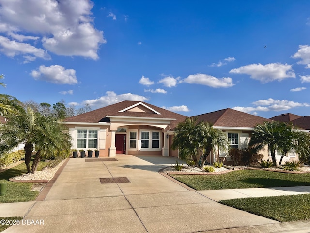 view of front of property featuring stucco siding and driveway