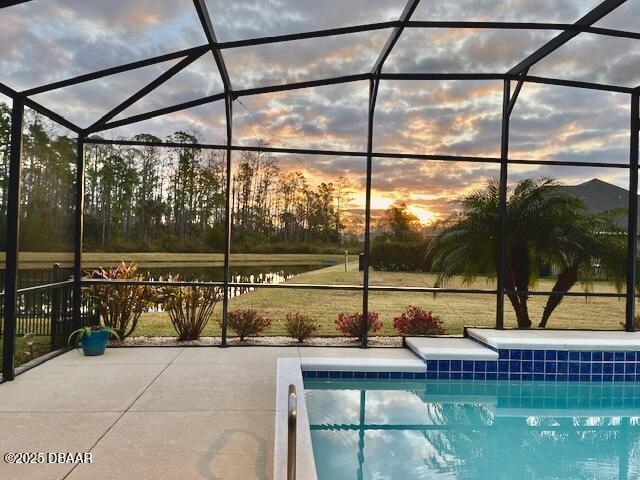 outdoor pool featuring a lanai and a patio