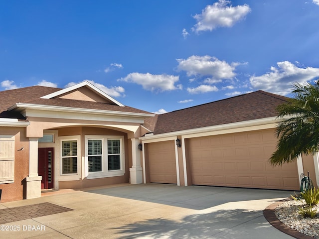 ranch-style house featuring stucco siding, concrete driveway, roof with shingles, and a garage