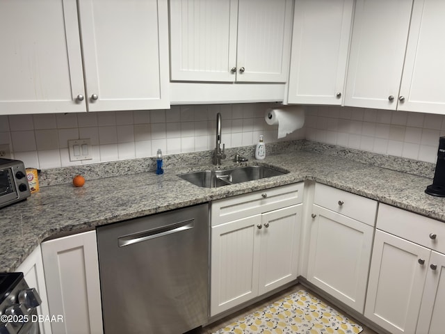 3580 S Ocean Shore Blvd Unit 404, Flagler Beach, FL 32136 - kitchen featuring stainless steel dishwasher, a sink, white cabinetry, tasteful backsplash, and light stone counters