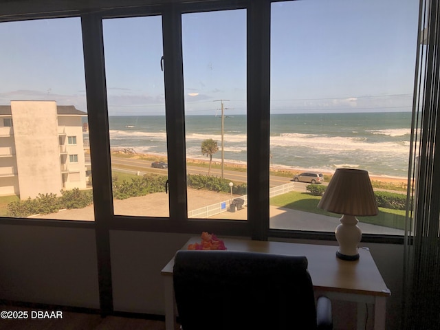 interior space with a water view and a view of the beach