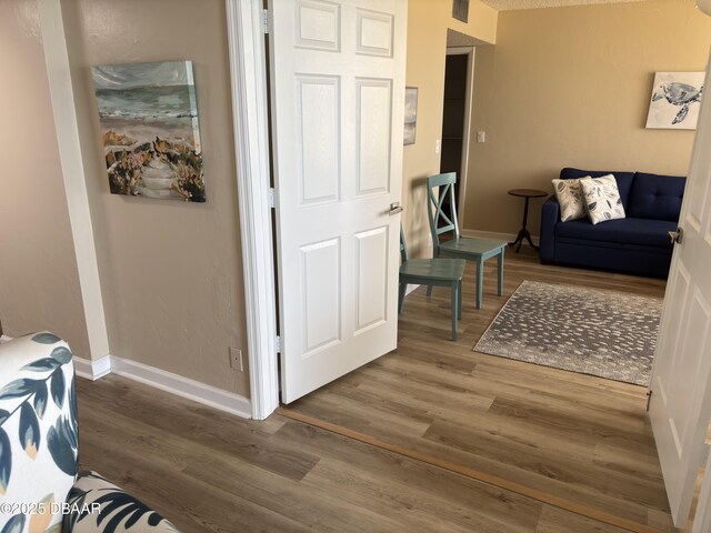 3580 S Ocean Shore Blvd Unit 404, Flagler Beach, FL 32136 - living room with wood finished floors and baseboards