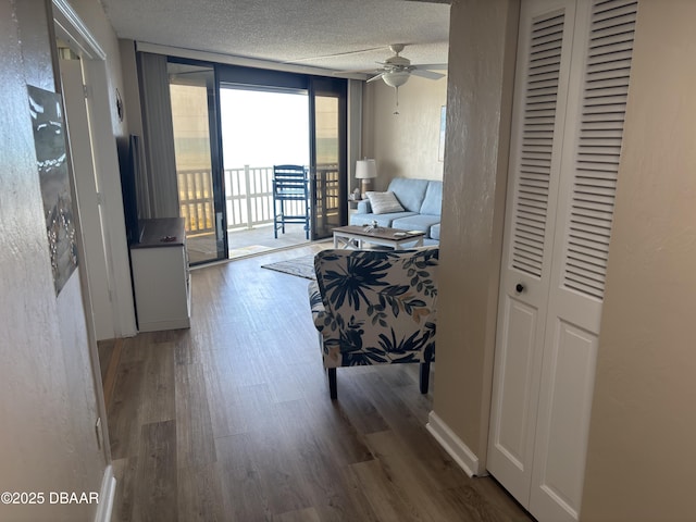 3580 S Ocean Shore Blvd Unit 404, Flagler Beach, FL 32136 - living room with wood finished floors, a textured ceiling, and ceiling fan