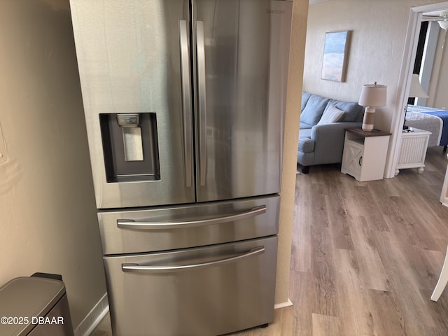 3580 S Ocean Shore Blvd Unit 404, Flagler Beach, FL 32136 - kitchen view of stainless steel refrigerator with ice dispenser and wood finished floors