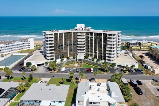 drone / aerial view featuring a water view and a view of the beach