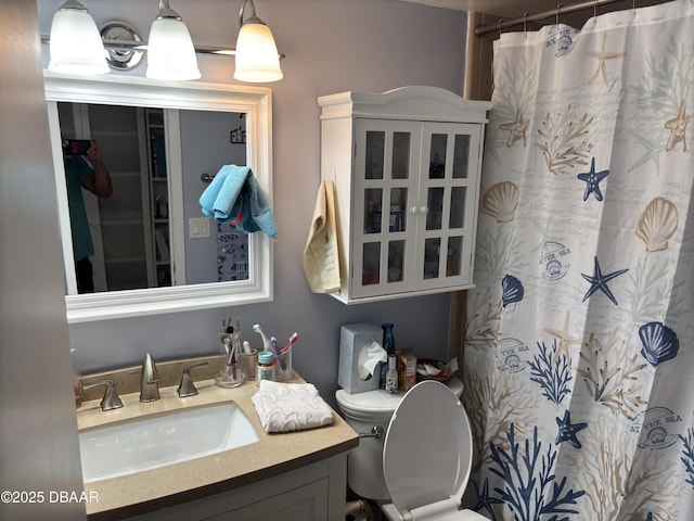 bathroom with walk in shower, vanity, and toilet