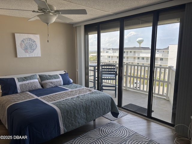 3580 S Ocean Shore Blvd Unit 404, Flagler Beach, FL 32136 - bedroom with wood finished floors, multiple windows, expansive windows, access to exterior, and ceiling fan