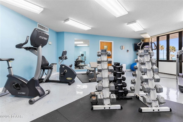 gym with a textured ceiling