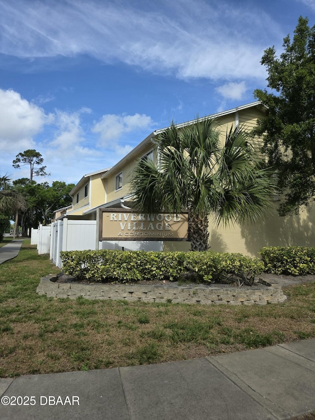 480 Reed Canal Rd Unit 55, South Daytona, FL 32119 - view of home's exterior featuring fence and stucco siding