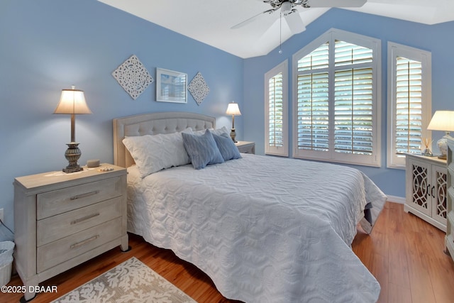 bedroom with wood-type flooring, vaulted ceiling, and ceiling fan