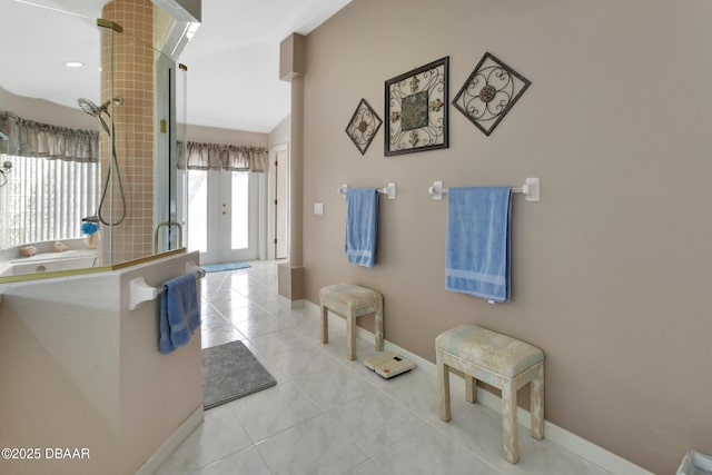 bathroom featuring french doors, tile patterned floors, a shower with shower door, and decorative columns