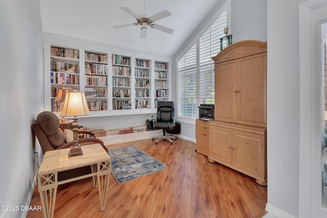 living area featuring light hardwood / wood-style flooring, ceiling fan, and vaulted ceiling