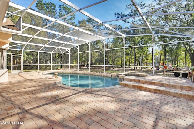 view of swimming pool featuring an in ground hot tub, a lanai, and a patio