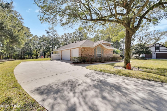 view of side of property featuring a yard and a garage