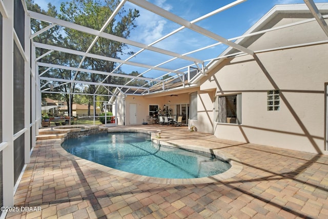 view of pool featuring a lanai, a patio, and ceiling fan