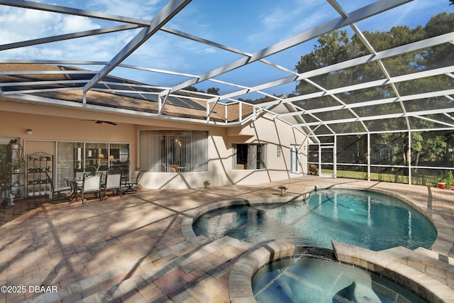 view of pool with a lanai, a patio area, and an in ground hot tub