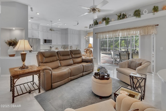 tiled living room with sink and ceiling fan