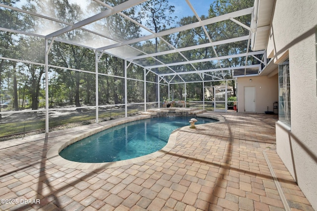 view of pool with a patio and a lanai