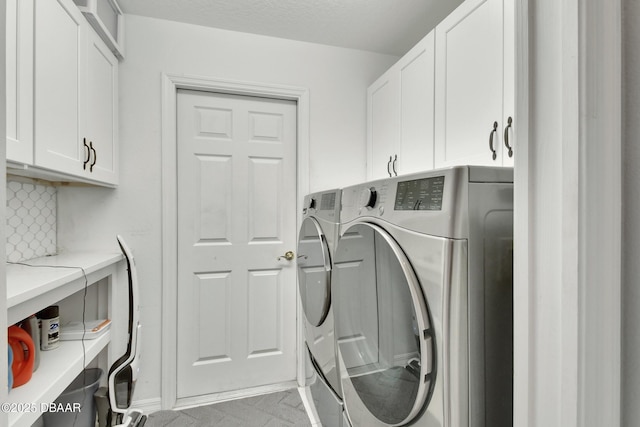 washroom with cabinets and separate washer and dryer