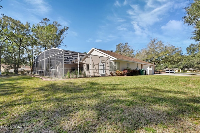 view of side of property with a lanai and a lawn