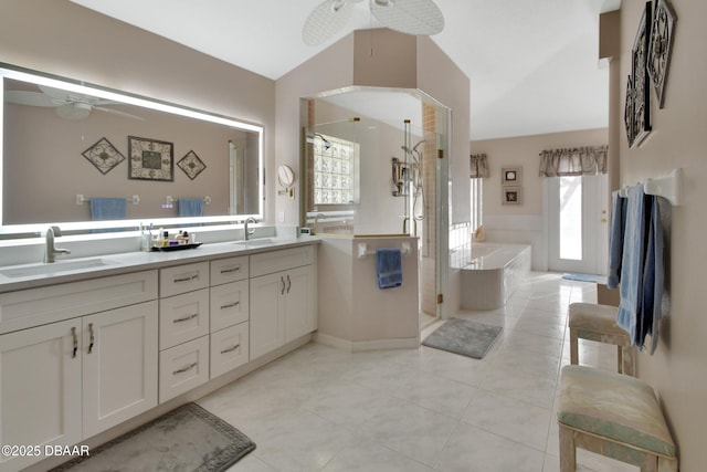 bathroom featuring vaulted ceiling, vanity, independent shower and bath, ceiling fan, and tile patterned flooring