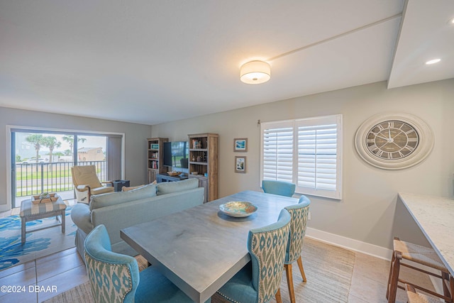 dining room featuring a wealth of natural light and light tile patterned flooring