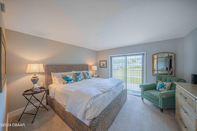 bedroom with access to exterior and light colored carpet