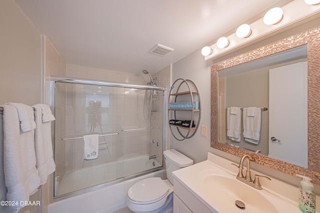 full bathroom with shower / bath combination with glass door, vanity, and toilet