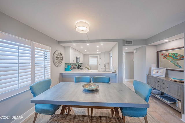 dining area with light tile patterned floors and sink