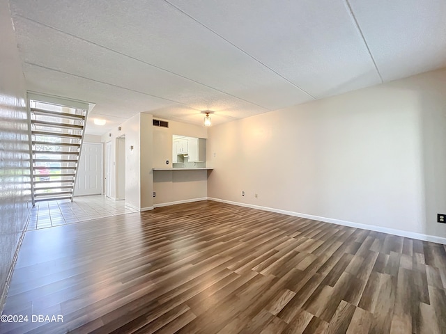 unfurnished living room featuring hardwood / wood-style flooring