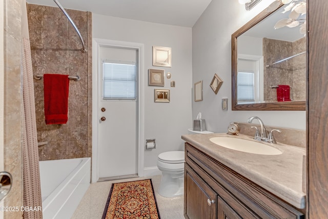 1713 Caldwell Rd, South Daytona, FL 32119 - bathroom featuring vanity, toilet, bathing tub / shower combination, a ceiling fan, and baseboards