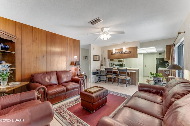 1713 Caldwell Rd, South Daytona, FL 32119 - living room featuring wood walls and ceiling fan