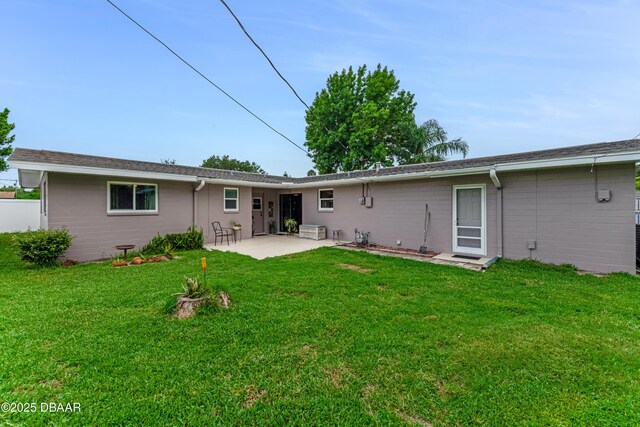 1713 Caldwell Rd, South Daytona, FL 32119 - back of property with a patio area and a yard