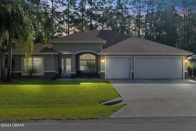 view of front of property featuring a lawn and a garage