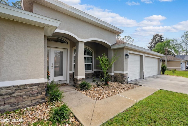 view of exterior entry with a garage