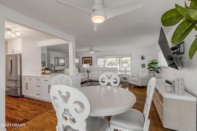 dining area with ceiling fan and dark hardwood / wood-style flooring