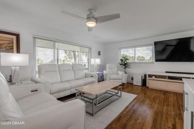 living room with ceiling fan, plenty of natural light, and dark hardwood / wood-style flooring