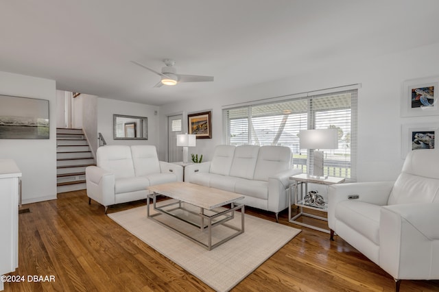 living room featuring hardwood / wood-style floors and ceiling fan