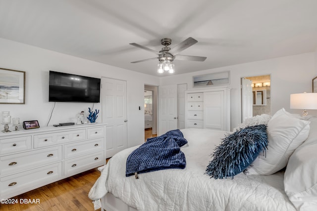 bedroom featuring ensuite bathroom, light hardwood / wood-style floors, and ceiling fan