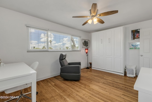 living area featuring light hardwood / wood-style flooring and ceiling fan