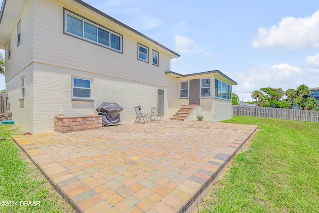 back of house with a yard and a patio area