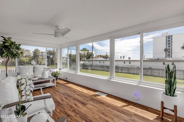 sunroom / solarium featuring a wealth of natural light and ceiling fan