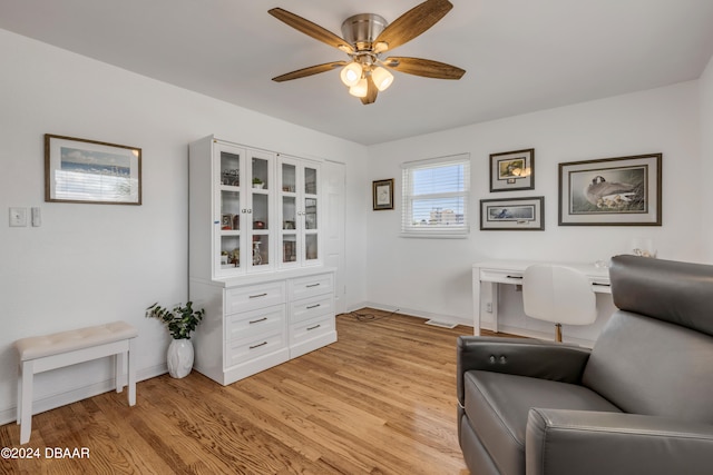 living area featuring ceiling fan and light hardwood / wood-style flooring