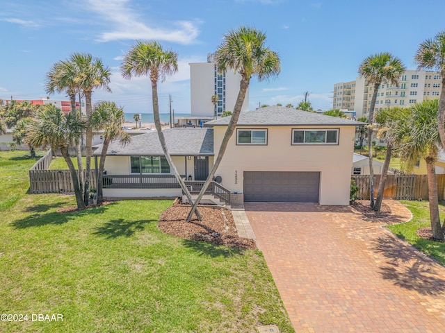 1232 Bel Aire Dr, Daytona Beach, FL 32118 - view of front of home with an attached garage, stucco siding, decorative driveway, and roof with shingles